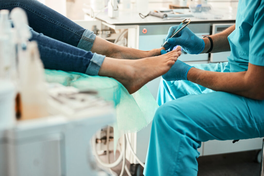 Professional doctor podiatrist doing medical pedicure procedure - PRINE Podiatry in Great Neck, NY