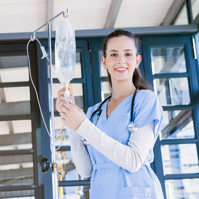 Nurse holding an IV bag for her IV Wellness patient